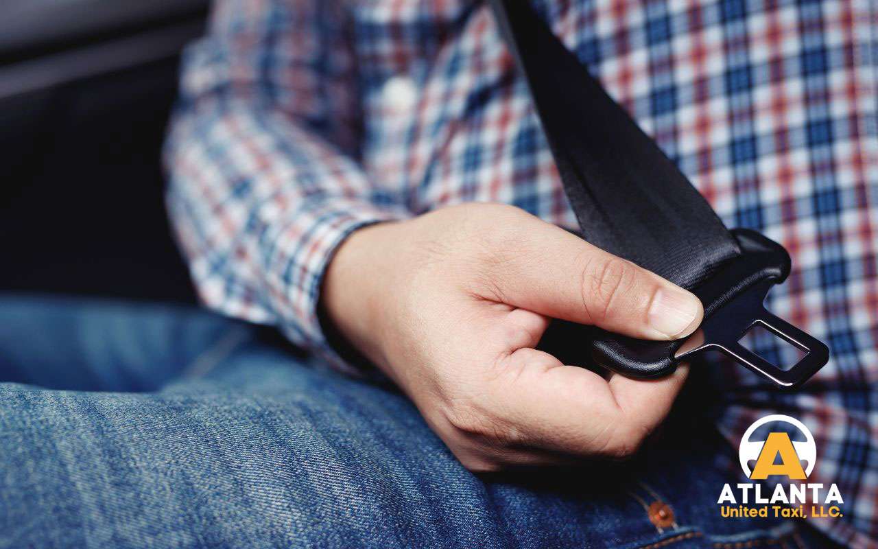 Passenger in car wearing a seat belt securely for safety.